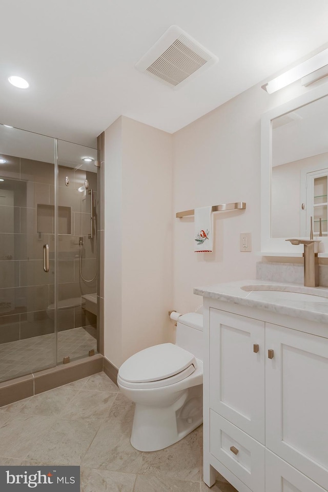 bathroom featuring an enclosed shower, vanity, and toilet