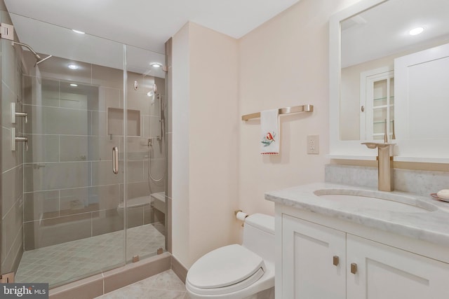 bathroom with toilet, tile patterned floors, walk in shower, and vanity