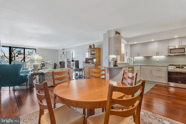 dining room with sink and hardwood / wood-style flooring