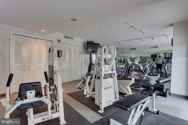 exercise room with a textured ceiling