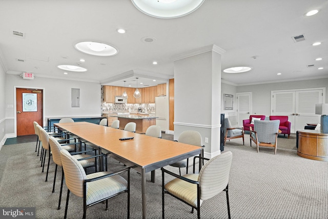 dining space featuring crown molding