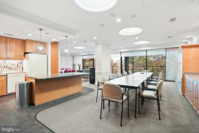 dining room with crown molding and floor to ceiling windows