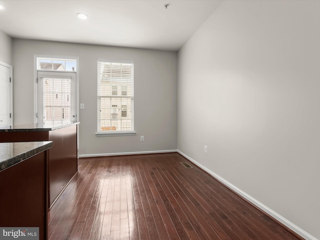 spare room with dark wood-type flooring