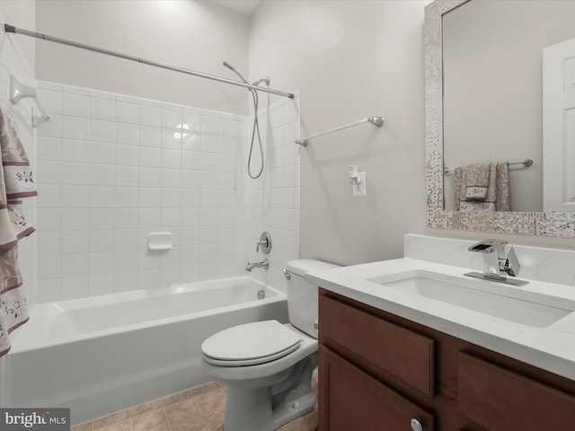 full bathroom with tile patterned floors, vanity, toilet, and tiled shower / bath combo