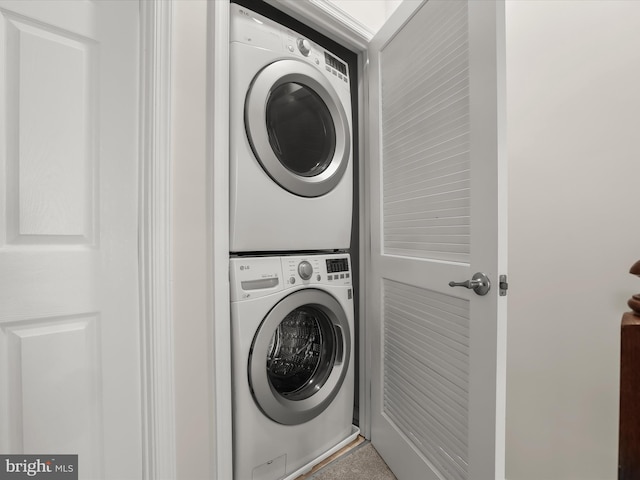 laundry area featuring stacked washer and clothes dryer