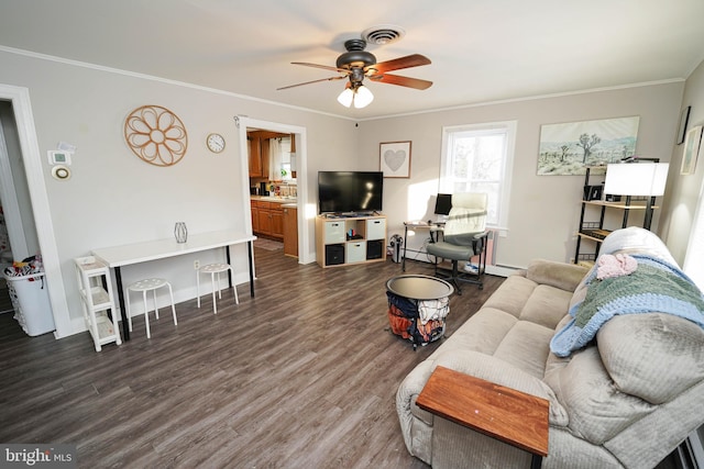 living room featuring dark wood-type flooring, ceiling fan, crown molding, and a baseboard radiator