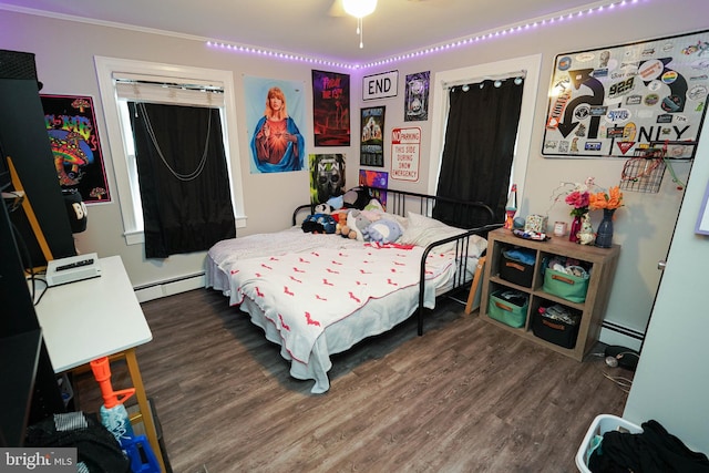 bedroom featuring a baseboard heating unit and dark wood-type flooring