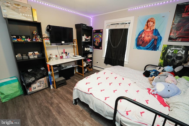 bedroom with a baseboard heating unit and dark wood-type flooring