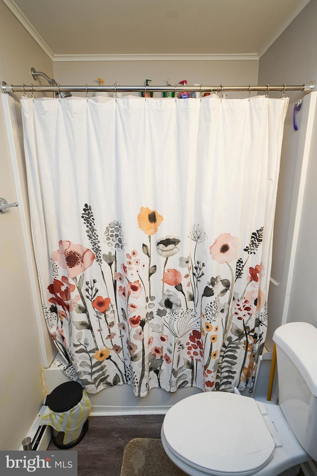 bathroom featuring curtained shower, wood-type flooring, ornamental molding, and toilet