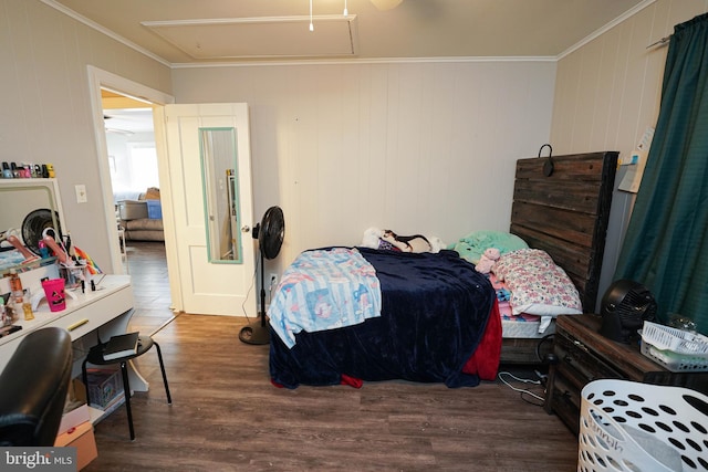 bedroom with crown molding and dark hardwood / wood-style floors