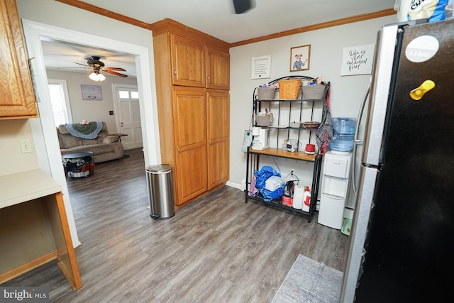 kitchen featuring crown molding, stainless steel refrigerator, ceiling fan, and light wood-type flooring