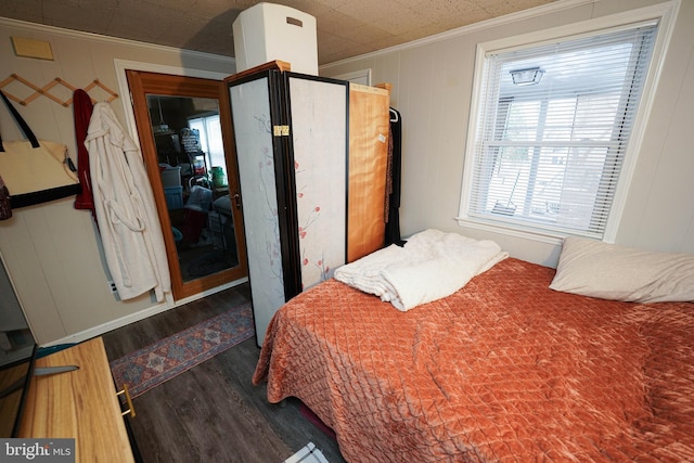 bedroom featuring crown molding and dark hardwood / wood-style flooring