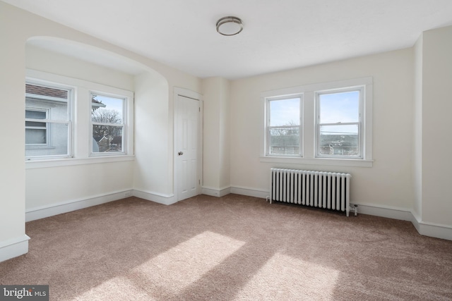 carpeted spare room with radiator