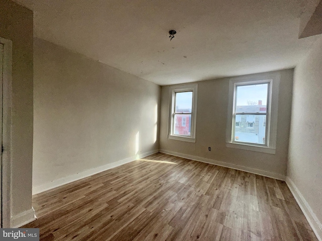 unfurnished room featuring hardwood / wood-style flooring