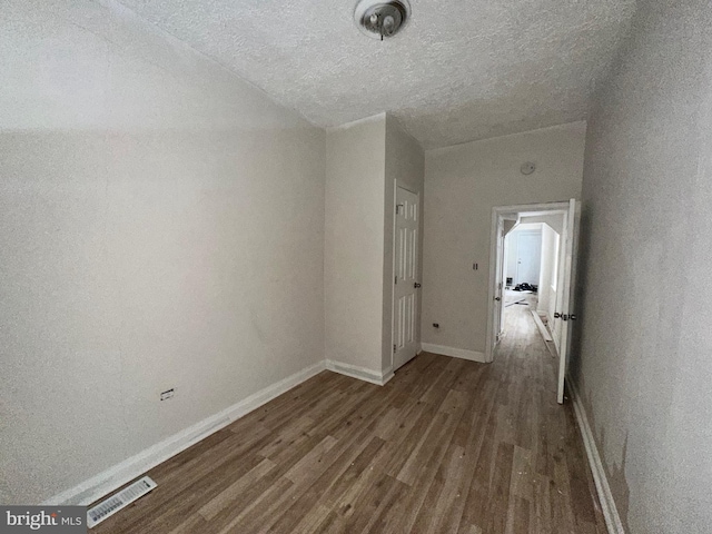 hall featuring dark hardwood / wood-style floors and a textured ceiling