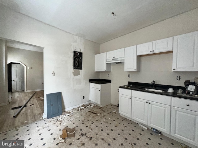 kitchen featuring white cabinets and sink