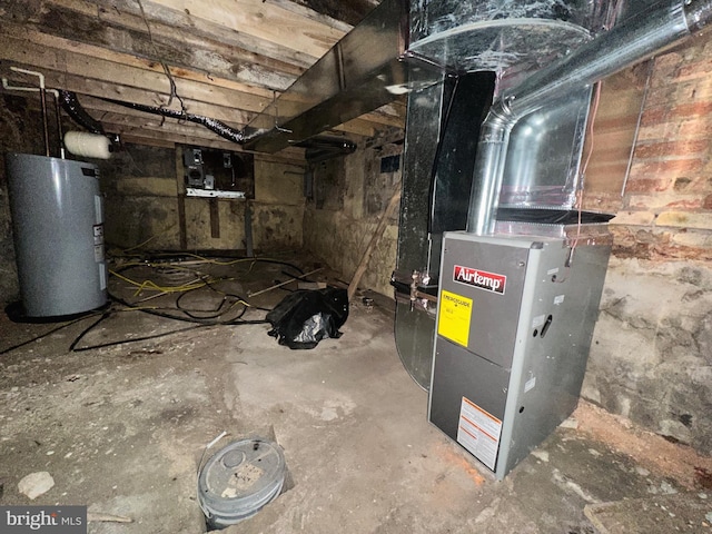 utility room featuring heating unit and electric water heater