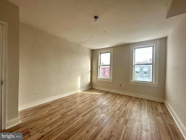 spare room with light hardwood / wood-style flooring