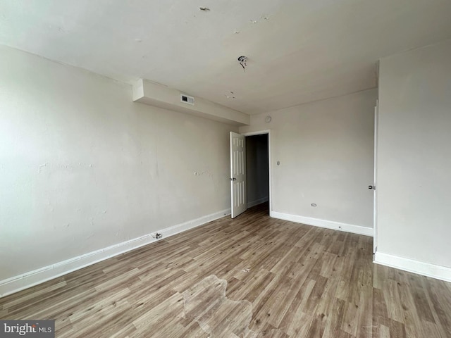 empty room with light hardwood / wood-style flooring