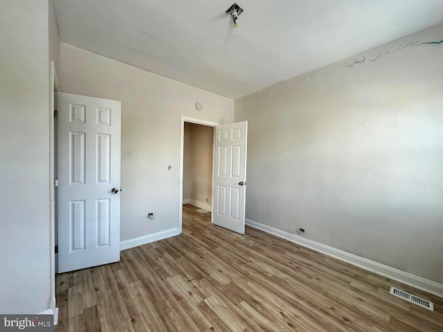 unfurnished bedroom featuring light wood-type flooring