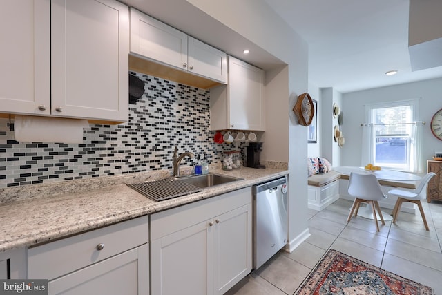 kitchen with dishwasher, white cabinets, backsplash, and sink