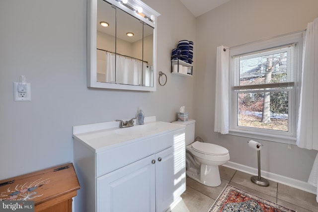 bathroom featuring toilet, a shower with shower curtain, tile patterned flooring, and vanity