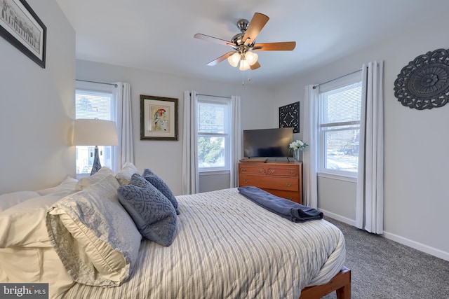 bedroom with ceiling fan and dark colored carpet