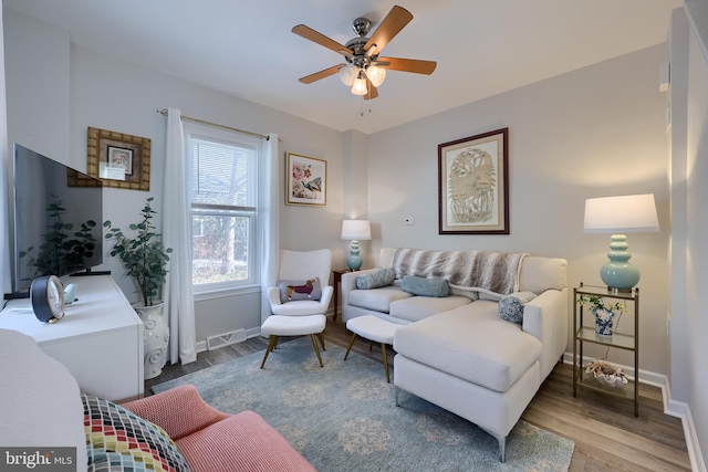 living room with hardwood / wood-style flooring and ceiling fan