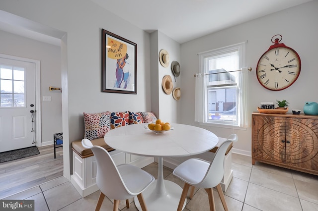 dining area featuring breakfast area and light tile patterned floors