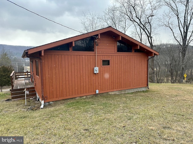 view of outbuilding with a lawn