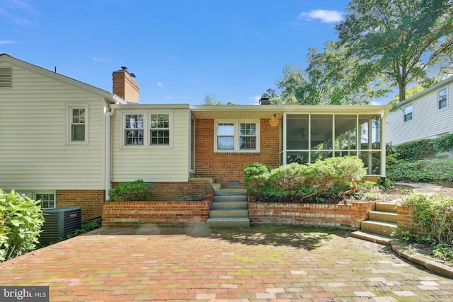 1113 Cameron Rd, Alexandria, VA 22308 - rear view of property with a chimney, a sunroom, and central AC