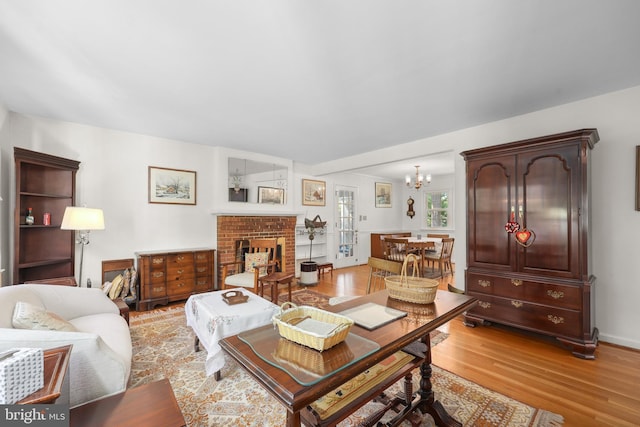 1113 Cameron Rd, Alexandria, VA 22308 - living area featuring light wood-style floors, a chandelier, and a fireplace