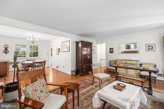 1113 Cameron Rd, Alexandria, VA 22308 - living area with a chandelier, light wood-style flooring, and baseboards