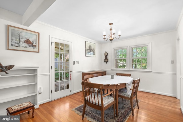 1113 Cameron Rd, Alexandria, VA 22308 - dining area with a chandelier, light wood finished floors, crown molding, and baseboards