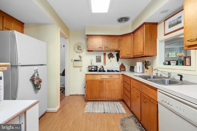 1113 Cameron Rd, Alexandria, VA 22308 - kitchen with white appliances, a sink, light wood-type flooring, and light countertops