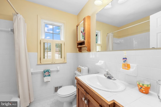1113 Cameron Rd, Alexandria, VA 22308 - full bathroom featuring vanity, toilet, tile patterned flooring, wainscoting, and shower / tub combo