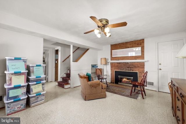 1113 Cameron Rd, Alexandria, VA 22308 - living area with tile patterned floors, a ceiling fan, stairway, and a fireplace
