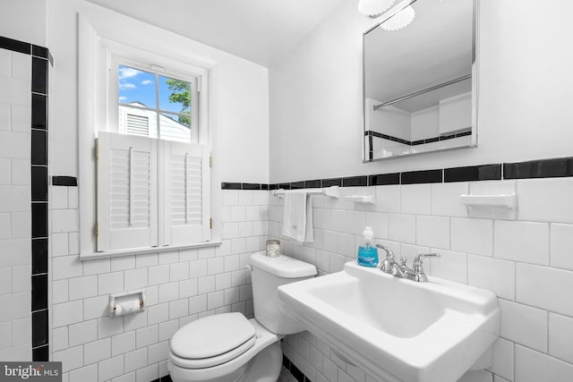 1113 Cameron Rd, Alexandria, VA 22308 - bathroom with toilet, a sink, wainscoting, and tile walls