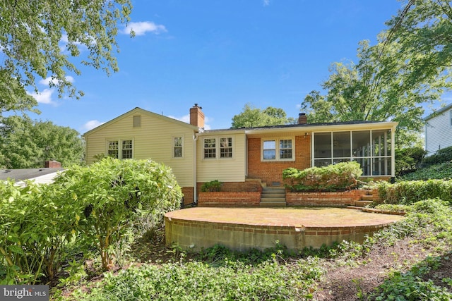 1113 Cameron Rd, Alexandria, VA 22308 - rear view of house with a chimney, a sunroom, brick siding, and a patio