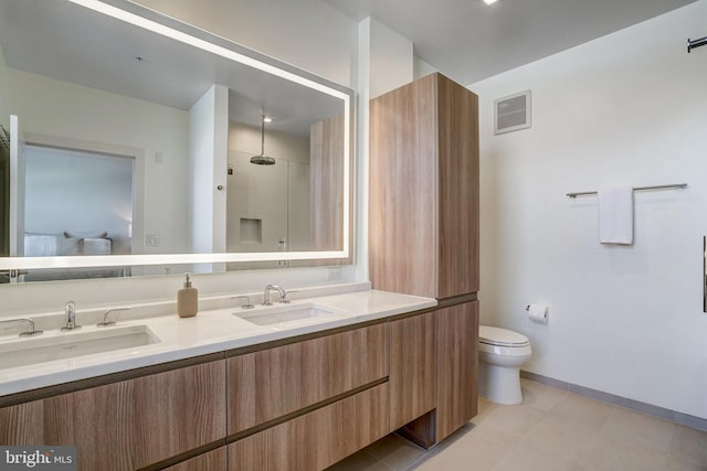 bathroom with toilet, tile patterned flooring, walk in shower, and vanity