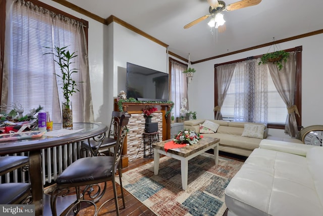 living room featuring ceiling fan, a healthy amount of sunlight, and ornamental molding