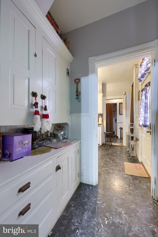 bar featuring white cabinets