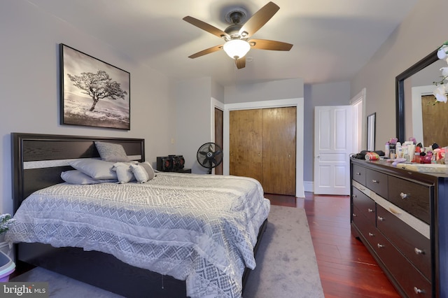 bedroom with ceiling fan, a closet, and dark hardwood / wood-style floors