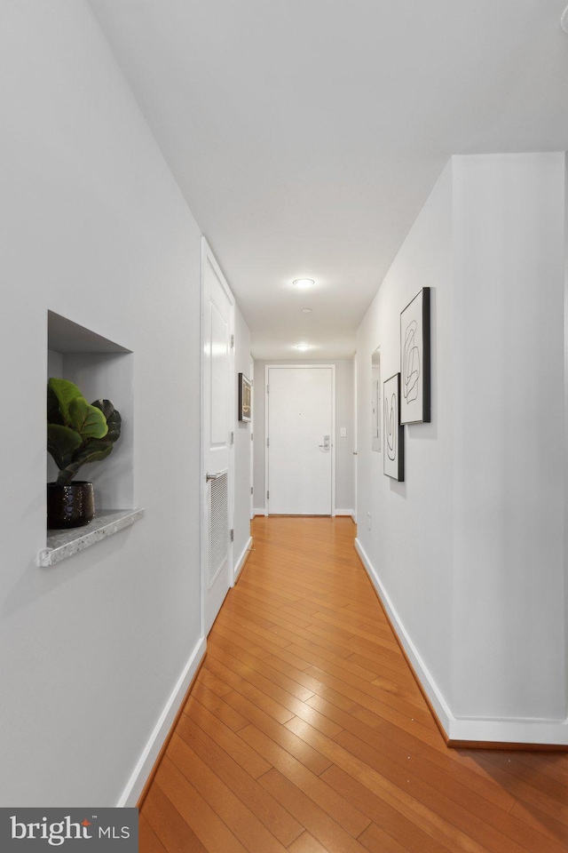 corridor with wood-type flooring