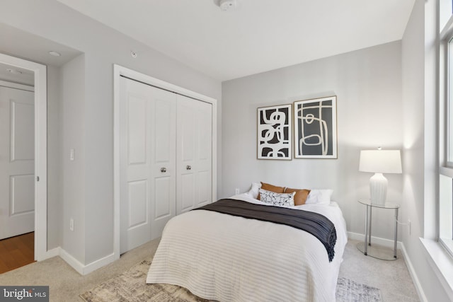 carpeted bedroom with a closet