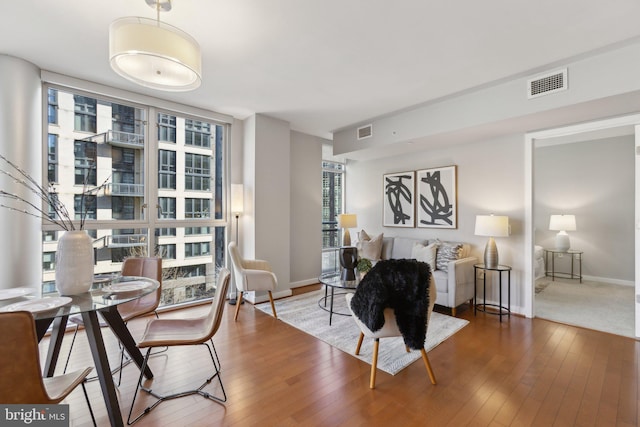 sitting room with hardwood / wood-style flooring and expansive windows