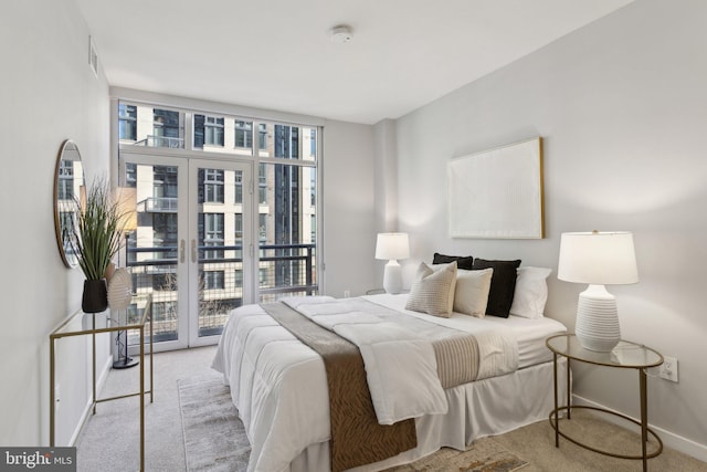 carpeted bedroom featuring a wall of windows, access to outside, and multiple windows