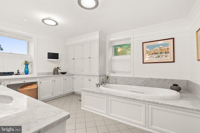 bathroom featuring ornamental molding, tile patterned floors, and a tub