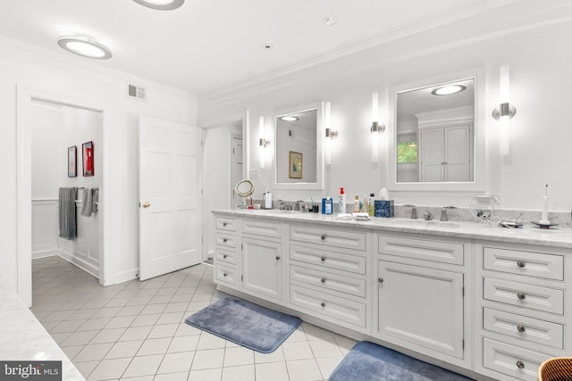 bathroom with ornamental molding, tile patterned floors, and vanity