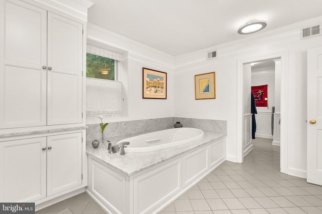 bathroom with crown molding, a bathing tub, and tile patterned flooring